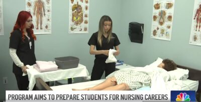 Nursing Assistant students practice in a medical setting